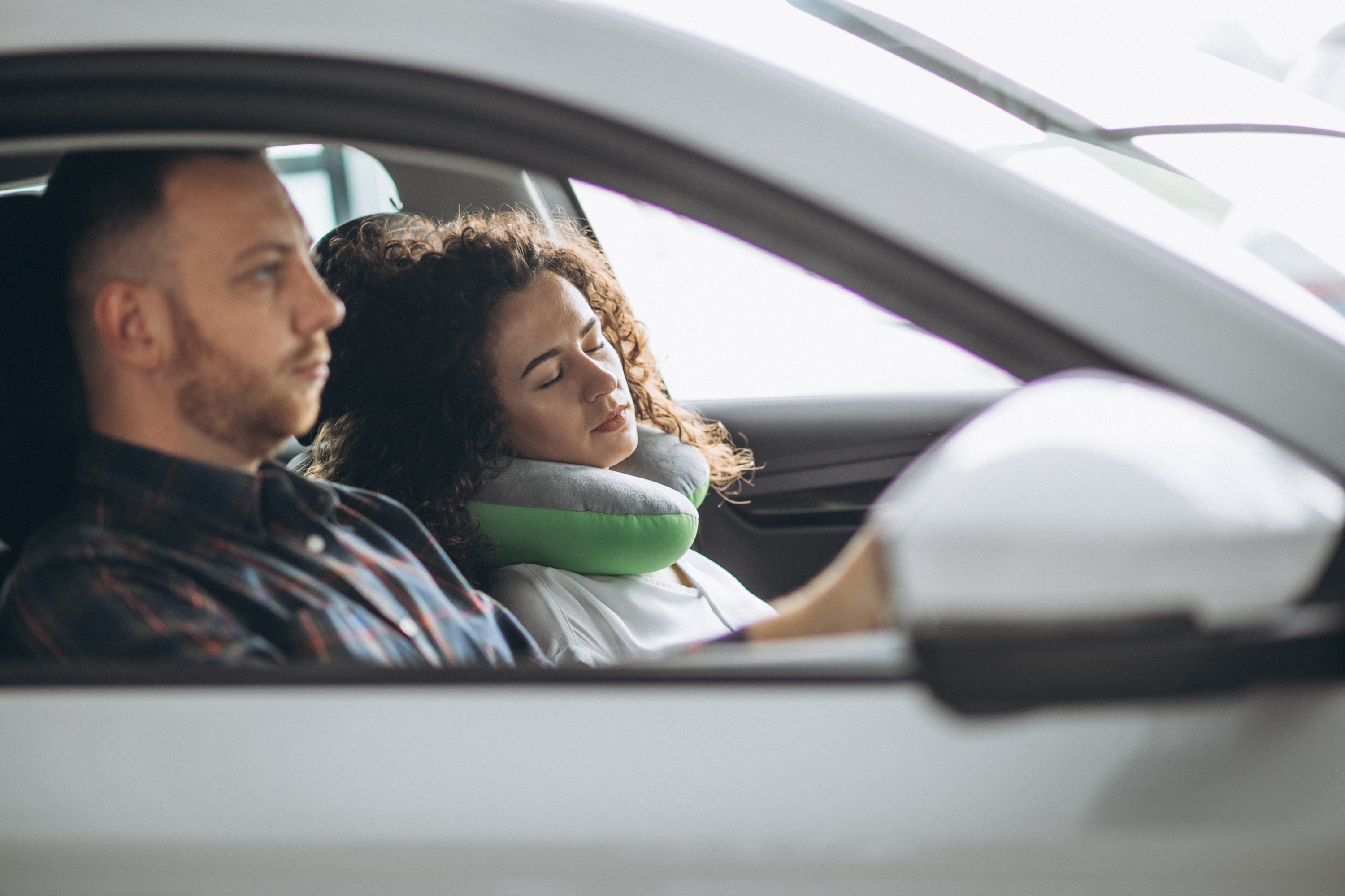 A woman sleeping in a comfortable family car